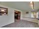 Open concept living room with wood-look tile floors and easy access to kitchen at 832 Seabreeze Dr, Ruskin, FL 33570
