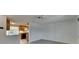 View of living room showing neutral paint and wood-look tile with an open view into the kitchen at 832 Seabreeze Dr, Ruskin, FL 33570