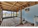 Enclosed patio with wooden flooring, a utility sink, and views of the canal at 832 Seabreeze Dr, Ruskin, FL 33570