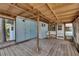 Enclosed porch with wood ceiling, wood floor, blue walls and access to the backyard at 832 Seabreeze Dr, Ruskin, FL 33570