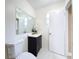 Bathroom featuring tiled floors, neutral paint, white fixtures and black vanity cabinet at 8345 81St Ct, Seminole, FL 33777