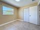 Bedroom features neutral paint, tile flooring, natural light and closet space for optimal storage at 8345 81St Ct, Seminole, FL 33777