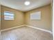 A simple bedroom provides neutral paint, tile flooring, and two windows for ample natural lighting at 8345 81St Ct, Seminole, FL 33777