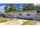 Exterior view of a well-maintained single-Gathering home with a tidy front lawn, and updated paint job at 8345 81St Ct, Seminole, FL 33777