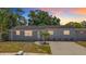 Charming single-story home with fresh gray paint and a well-manicured front yard and a large driveway at 8345 81St Ct, Seminole, FL 33777