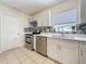 Updated kitchen features stainless steel appliances, tile backsplash, and crisp white cabinetry at 8345 81St Ct, Seminole, FL 33777
