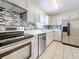 Well-lit kitchen with modern stainless steel appliances, contemporary backsplash, and light countertops at 8345 81St Ct, Seminole, FL 33777