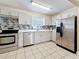 Updated kitchen with stainless steel appliances, sleek white cabinets, and a modern backsplash at 8345 81St Ct, Seminole, FL 33777