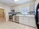 Modern kitchen showcasing updated stainless steel appliances, stylish backsplash, and sleek white cabinetry at 8345 81St Ct, Seminole, FL 33777