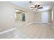 Open living room featuring neutral paint, tile flooring, and a ceiling fan, and open access to the kitchen at 8345 81St Ct, Seminole, FL 33777
