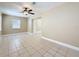 Bright living room featuring neutral walls, tile flooring, large windows, and a modern ceiling fan at 8345 81St Ct, Seminole, FL 33777