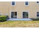 Back patio with sliding glass doors offering easy access to indoor living spaces at 8518 Broken Willow Ct, Tampa, FL 33647