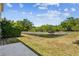View of the backyard, featuring a pond and green space, perfect for outdoor enjoyment at 8518 Broken Willow Ct, Tampa, FL 33647