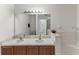 Bright bathroom with double sinks, tile accents, and a separate shower and tub at 8518 Broken Willow Ct, Tampa, FL 33647