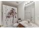 Charming bathroom with vanity, mirror, and shower with unique curtain at 8518 Broken Willow Ct, Tampa, FL 33647