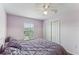 Comfortable bedroom with natural light, fan, and closet at 8518 Broken Willow Ct, Tampa, FL 33647