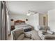 Bright bedroom featuring a ceiling fan, comfortable seating, and a decorative headboard at 8518 Broken Willow Ct, Tampa, FL 33647