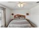 Bedroom featuring a wooden headboard, bedside tables, and a bright ceiling fan at 8518 Broken Willow Ct, Tampa, FL 33647