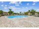 Community pool with surrounding lounge chairs and lush landscaping at 8518 Broken Willow Ct, Tampa, FL 33647