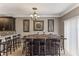 Dining area featuring dark wood bar stool seating and a view into an open kitchen at 8518 Broken Willow Ct, Tampa, FL 33647