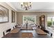 Elegant dining room featuring a large dark wood table, chandelier lighting, and neutral wall color at 8518 Broken Willow Ct, Tampa, FL 33647