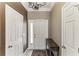 Inviting foyer with tile floors, a decorative table, and white doors, leading to the rest of the home at 8518 Broken Willow Ct, Tampa, FL 33647