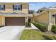 Charming two-story home with a well-manicured lawn and attached garage at 8518 Broken Willow Ct, Tampa, FL 33647