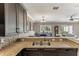 Open kitchen with granite countertops that looks into a dining area featuring a large dark wood table at 8518 Broken Willow Ct, Tampa, FL 33647