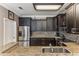 Spacious kitchen featuring stainless steel refrigerator, dark wood cabinets, and granite countertops at 8518 Broken Willow Ct, Tampa, FL 33647