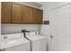 Well-equipped laundry room with washer, dryer, and storage cabinets at 8518 Broken Willow Ct, Tampa, FL 33647