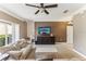 Cozy living room with a ceiling fan, comfortable seating, neutral tones, and stairs at 8518 Broken Willow Ct, Tampa, FL 33647