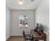 Bright office with a desk and a view of the neighborhood at 8518 Broken Willow Ct, Tampa, FL 33647
