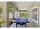 Outdoor ping pong table on a covered patio for recreational enjoyment at 8518 Broken Willow Ct, Tampa, FL 33647