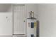 Utility closet featuring a water heater and access door at 8518 Broken Willow Ct, Tampa, FL 33647