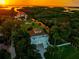 Breathtaking aerial view showcasing the waterfront home, a boat canal, lush greenery, and picturesque sunset backdrop at 8717 Betty St, Port Richey, FL 34668