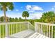 Backyard featuring tropical plants, view of a canal, and a glimpse of condos near the water at 8717 Betty St, Port Richey, FL 34668