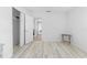 Bright bedroom featuring light wood-look floors, fresh white walls, and a closet at 8717 Betty St, Port Richey, FL 34668