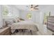 Bright bedroom with generous light, ceiling fan, and wood-look floors at 8717 Betty St, Port Richey, FL 34668