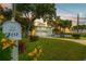 Home featuring a well-maintained front yard, a mailbox, and a sunset at 8717 Betty St, Port Richey, FL 34668