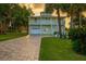 Charming two-story home featuring a driveway, stairs, and tropical plants at 8717 Betty St, Port Richey, FL 34668