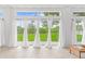 Bright sunroom featuring tile floors, floor to ceiling windows, and backyard view at 8717 Betty St, Port Richey, FL 34668