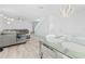 Open concept living room and dining area with modern lighting and neutral decor at 8717 Betty St, Port Richey, FL 34668