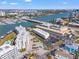 Wide aerial shot showcasing the waterfront condo near a marina, and bridge at 9755 Harrell Ave # 101, Treasure Island, FL 33706