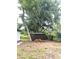 The backyard contains a storage shed and a stack of firewood at 9830 Sheryl Dr, New Port Richey, FL 34654