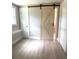 Bright bedroom with barn door access to bathroom at 9830 Sheryl Dr, New Port Richey, FL 34654