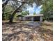 Charming single-story home with attached carport and mature trees in a peaceful setting at 9830 Sheryl Dr, New Port Richey, FL 34654