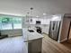 Modern kitchen featuring an island, stainless steel appliances, and bright white cabinetry at 9830 Sheryl Dr, New Port Richey, FL 34654