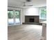Spacious living room with a stone fireplace, wood beam accents, and sliding glass doors at 9830 Sheryl Dr, New Port Richey, FL 34654