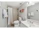 Bathroom with white fixtures, neutral tile, and a shower with curtain at 6914 N Ola Ave, Tampa, FL 33604