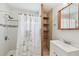 Cozy bathroom features a shower with white tiling and a mirrored cabinet above the vanity at 6914 N Ola Ave, Tampa, FL 33604